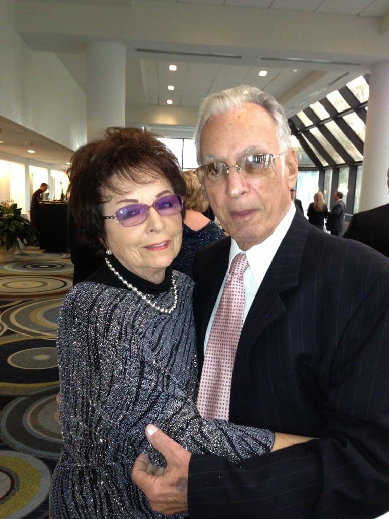 Roberta and her husband Irv, smiling together at a family event